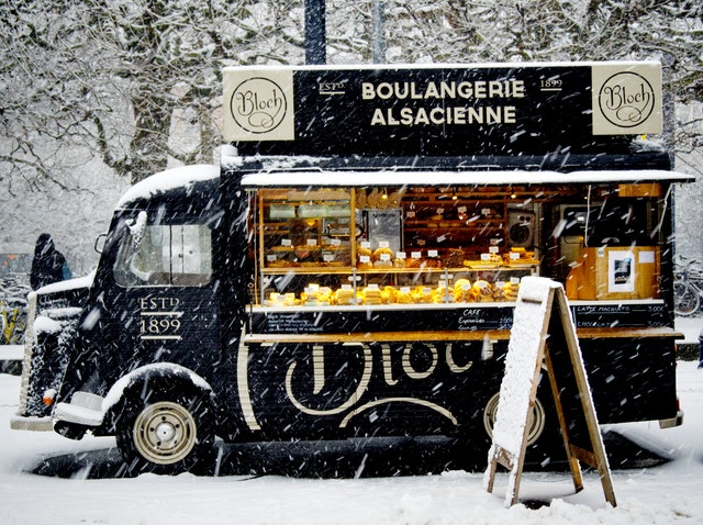 Black food truck in snow