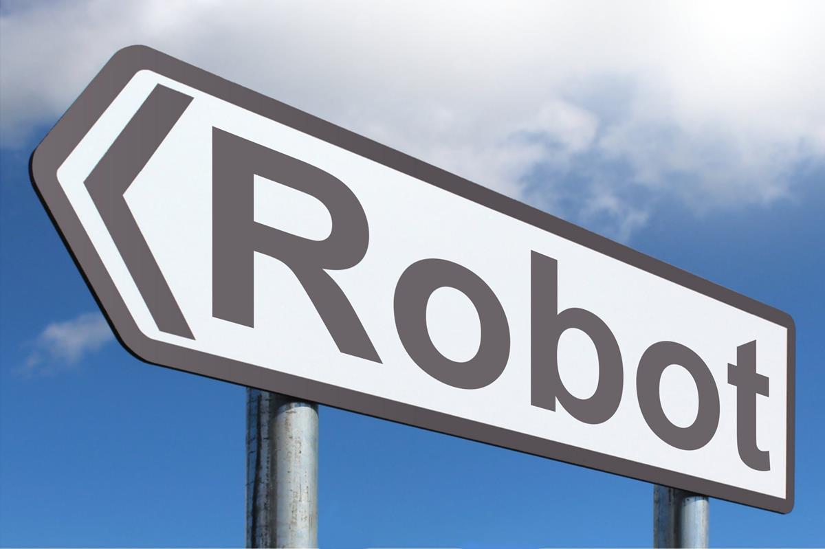 Black and white arrow sign with word "Robot". Set against blue sky with clouds.