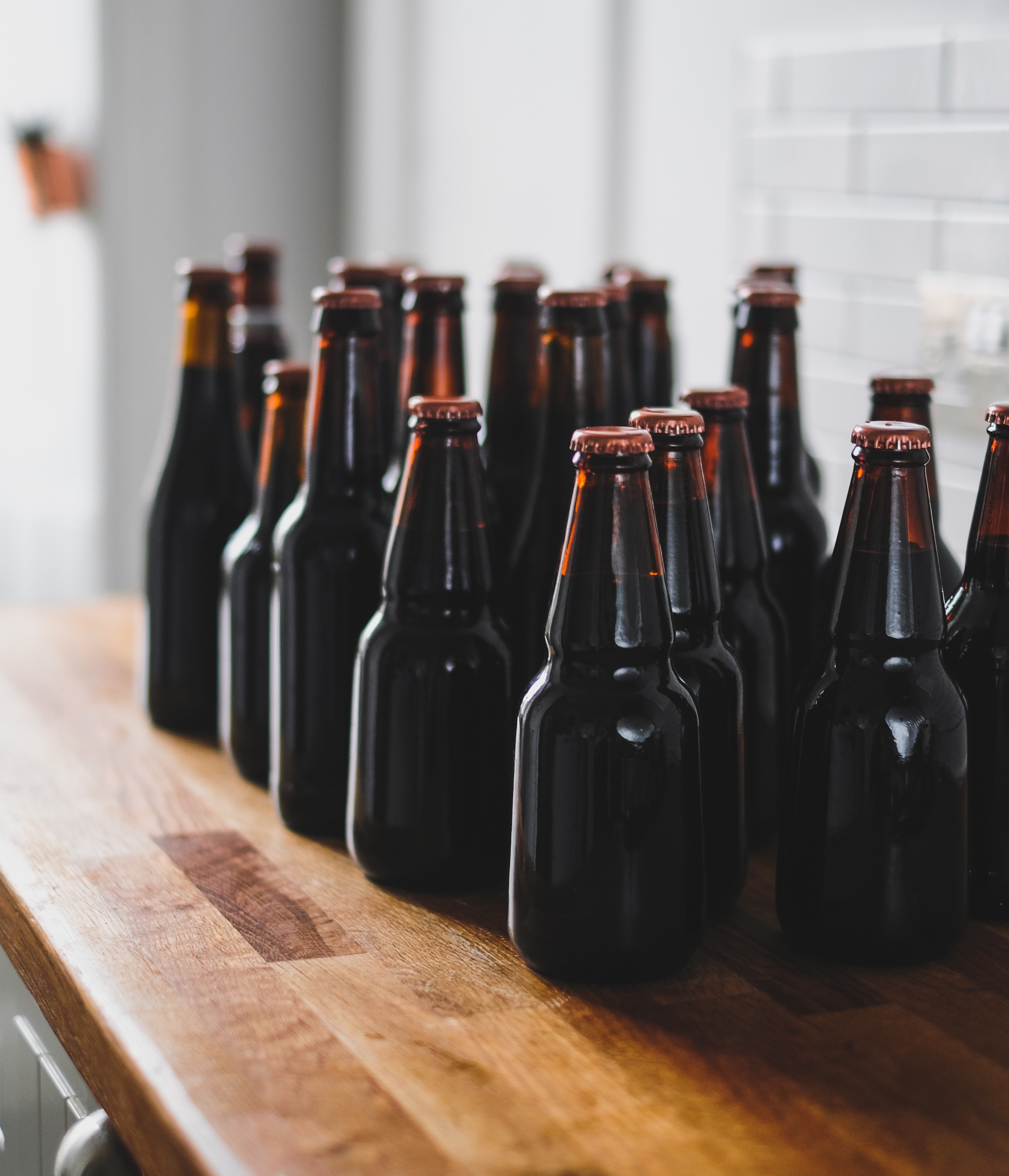 Brown beer bottles on wooden counter