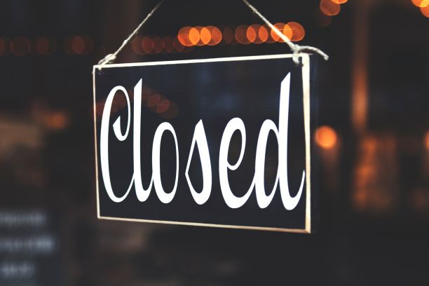 "Closed" sign on glass door.