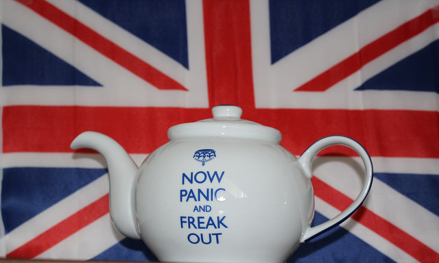White Teapot that says "Now Panic and Freak Out" with British flag in the background.