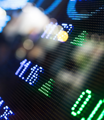 Supply Chain Scene, image of a stock ticker board out of focus