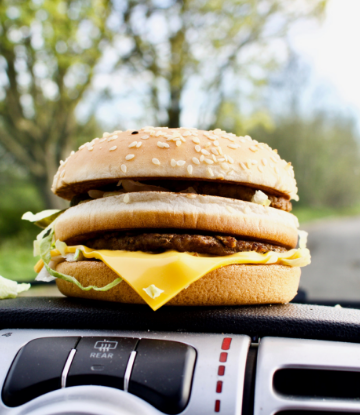 Supply Chain Scene, image of a cheeseburger on a car dashboard 
