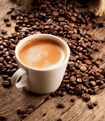 Supply Chain Scene, image of a cup of coffee surrounded by roasted coffee beans 