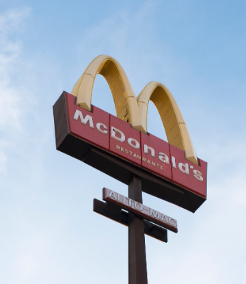 Worm's view of McDonald's Golden Arches Sign against blue skies 
