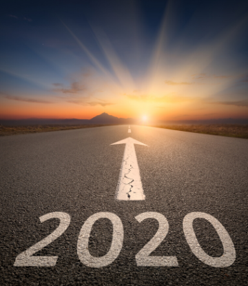 Image of 2020 painted on a highway, with arrow pointing toward the sunset 