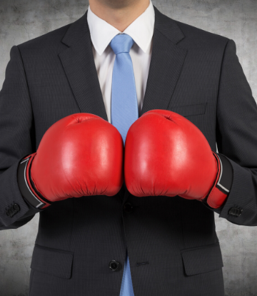 SCS, image of a man in a suit with boxing gloves on 