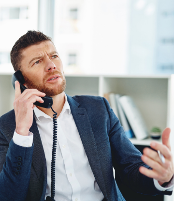 Image of an annoyed business person on the phone 