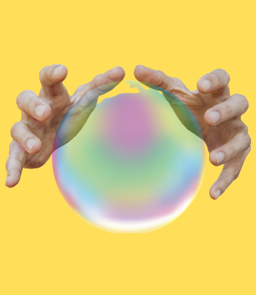 hands around a crystal ball on a yellow background 