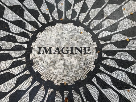 The word "Imagine" in black and white mosaic tile.