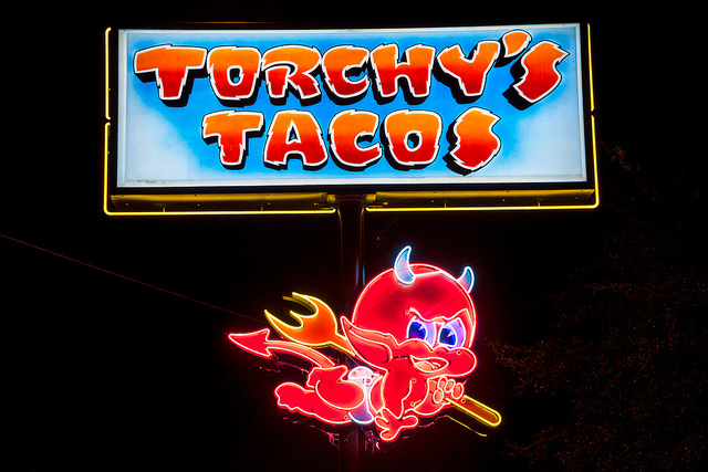 Neon Torchy's Taco sign with red devil