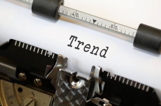 The word "Trend" typed on a white piece of paper and still in typewriter.