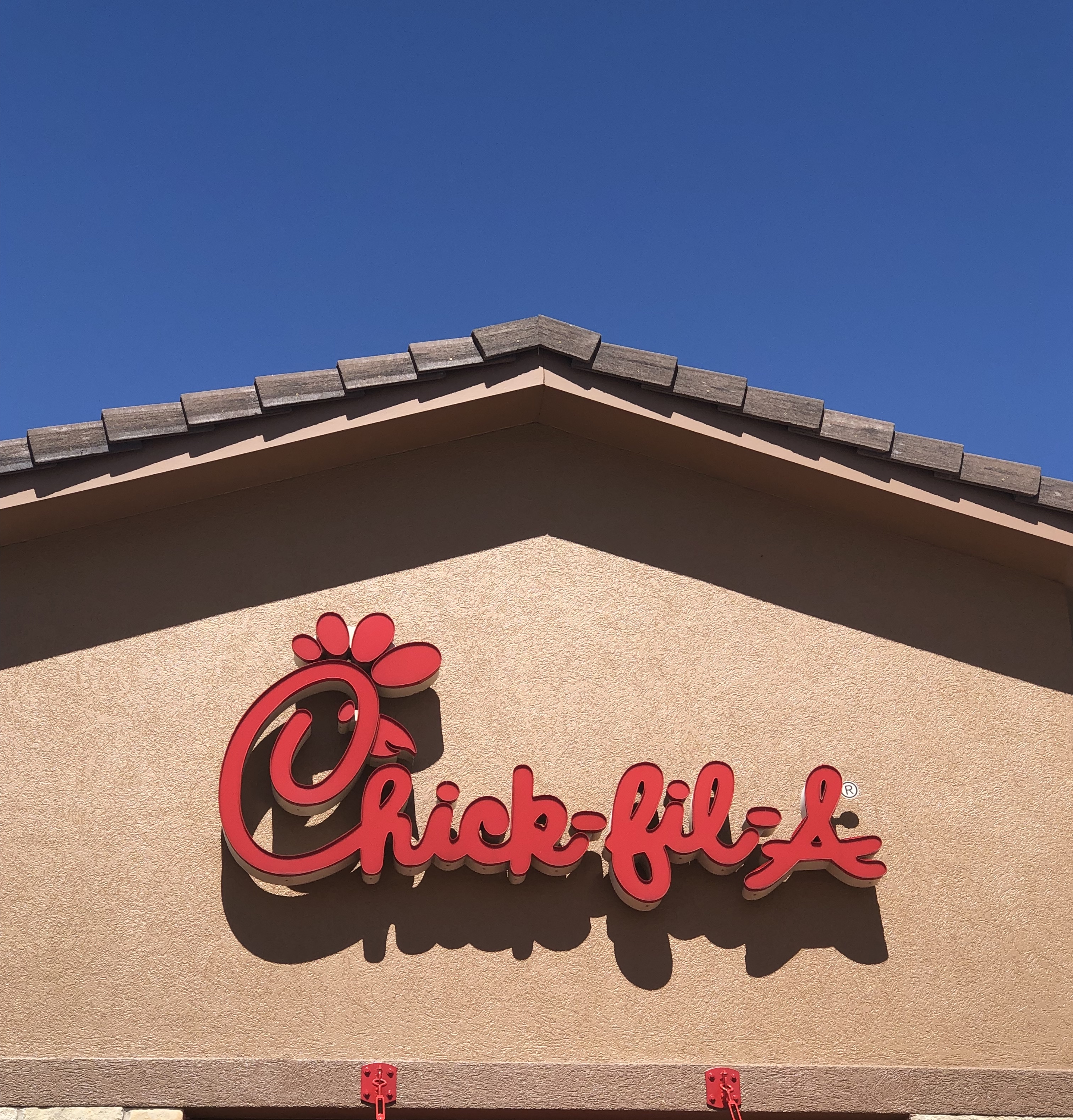 Supply Chain Scene, image of a Chick-fil-A store sign with blue sky background 