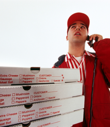 Supply Chain Scene, image of delivery man with stack of pizza boxes