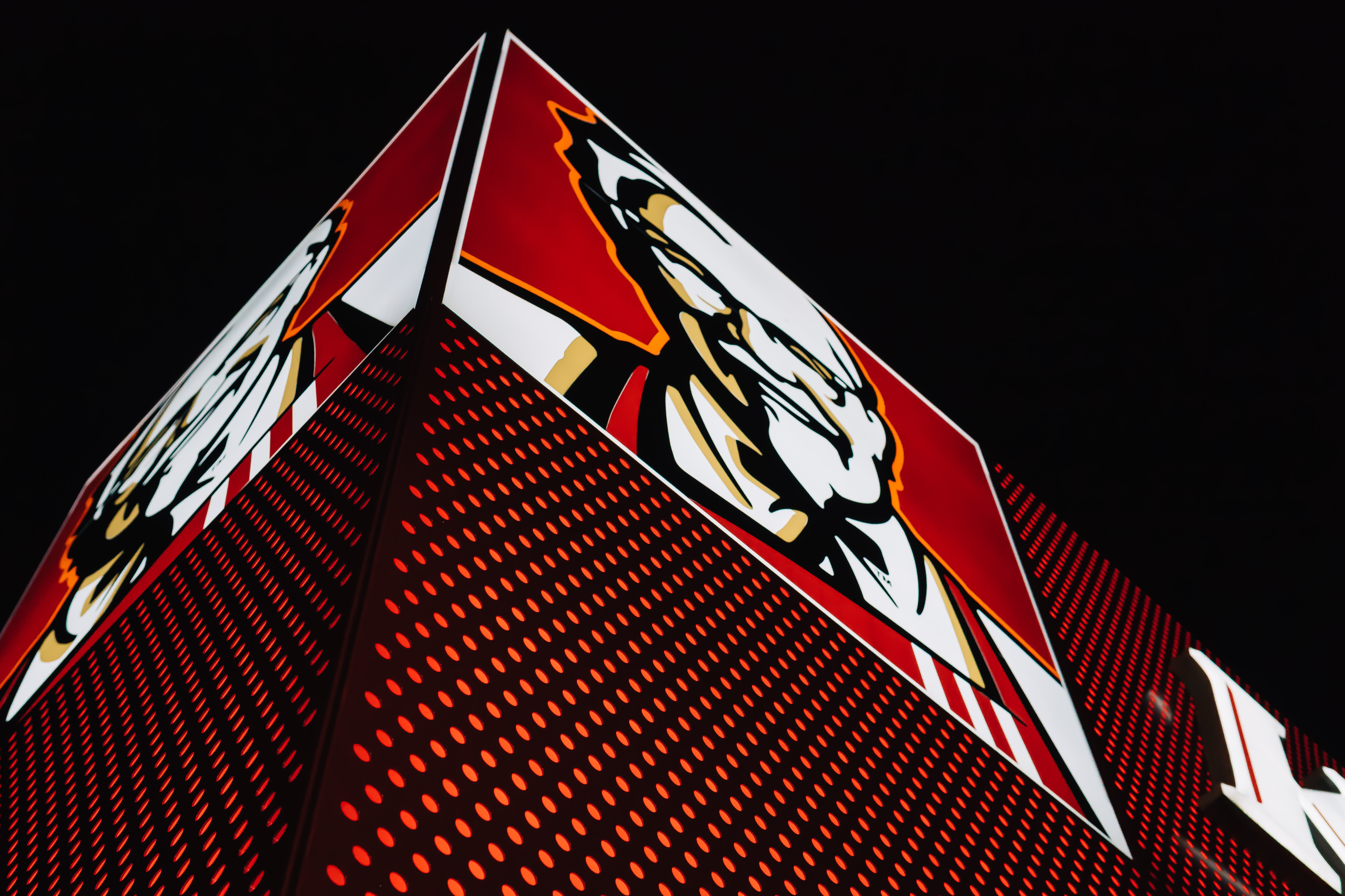 Supply Chain Scene, image of a lighted KFC sign on a corner building 