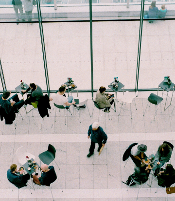 Supply Chain Scene, overhead image of business people in small groups, next to large office windows