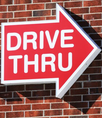 Supply Chain Scene, image of a red, drive-thru sign in the shape of an arrow with white letters in