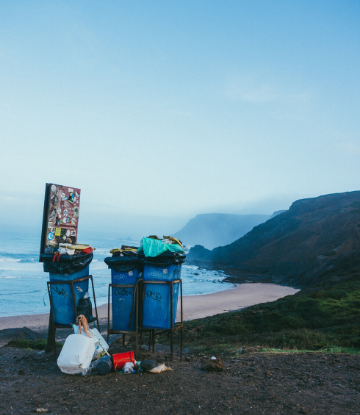 Supply Chain Scene, image of blue trash bins next to the beach 