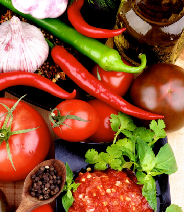 Image of fresh chipotle chili, tomatoes, garlic and ingredients to make salsa 