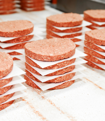 Image of stacks of raw impossible burger patties 