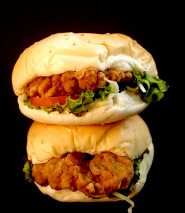 Scs, image of two, small fried chicken sandwiches stacked on top of each other 