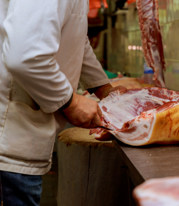 SCS, image of a butcher hand cutting a side of meat 