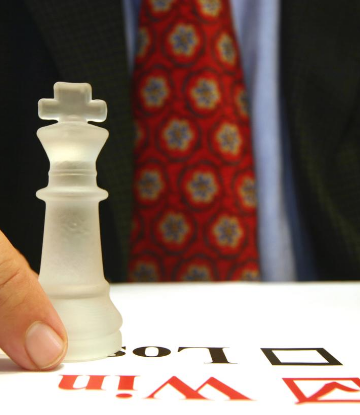 Image of a chess piece on top of check boxes marked "win" or "lose" 