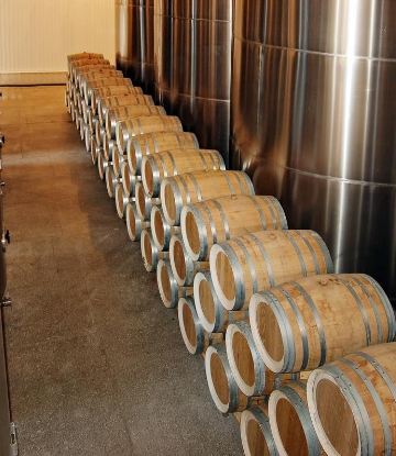 Image of wine barrels stacked in a winery