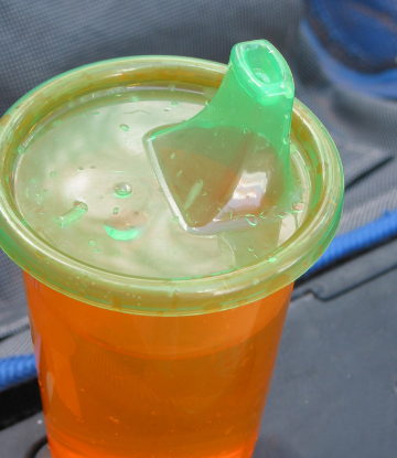 Image of a plastic sippy cup with built in short straw on the lid 