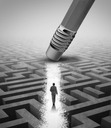 Image of a man walking through a maze with an earaser clearing his path 
