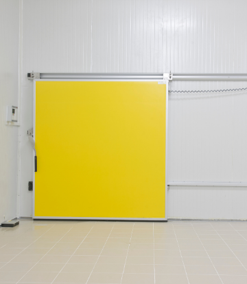 Image of a closed yellow door inside an empty food cold storage freezer