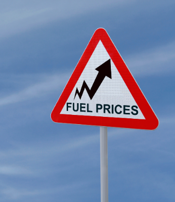 Image of a triangle sign with arrow pointing up that reads FUEL PRICES 