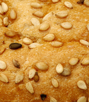 Closeup image of a sandwich bun covered with sesame seeds