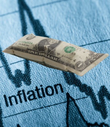 image of a puffed up dollar bill on a line chart that reads "inflation" 