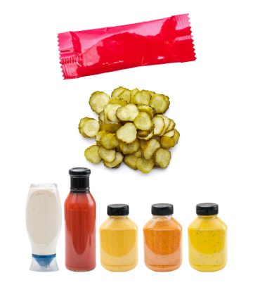Image of a ketchup packet, pickels and other condiments 