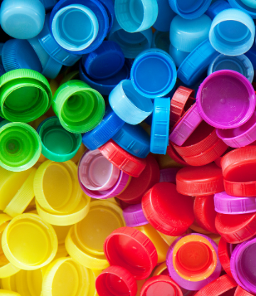 Image of a pile of brightly colored plastic bottle caps 