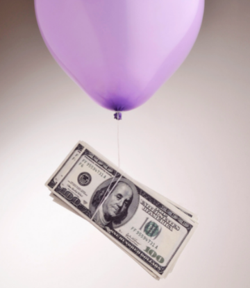 Image of a balloon floating away with $100 bills 