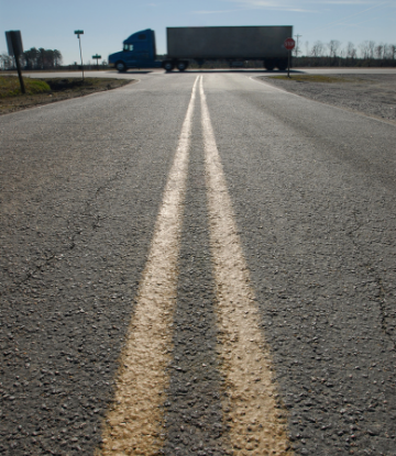 Image of a road with a truck crossing an intersection 