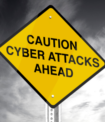 Image of a caution sign that reads Cyber Attackers Ahead 