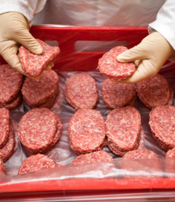 Image of person sorting raw hamburger patties 