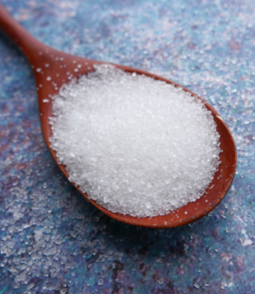 Image of a wooden tablespoon of sugar