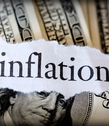 the word INFLATION on top of $100 bills 