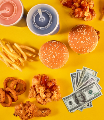 An assortment of fast food items next to cash money