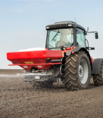 Tractor spreading fertilizer on a field 