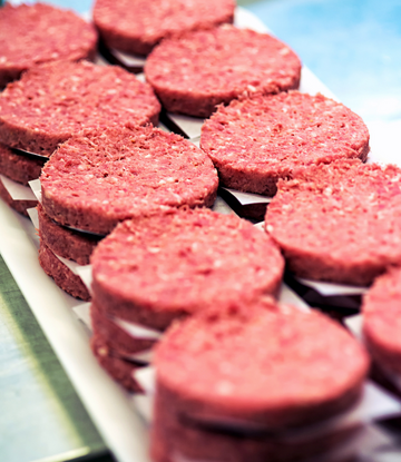 Raw beef patties on a tray