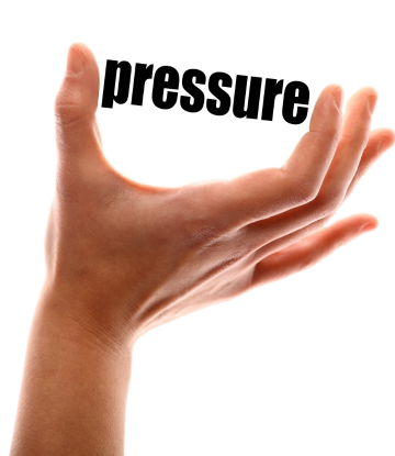 Hand gripping the word "pressure" 