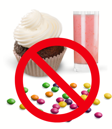 a ban sign on a white frosted cupcake, candy and red drink