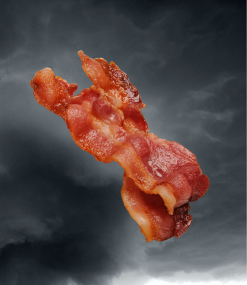 cooked bacon strips against apocolyptic storm clouds