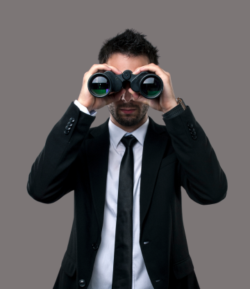 man looking through binoculars 