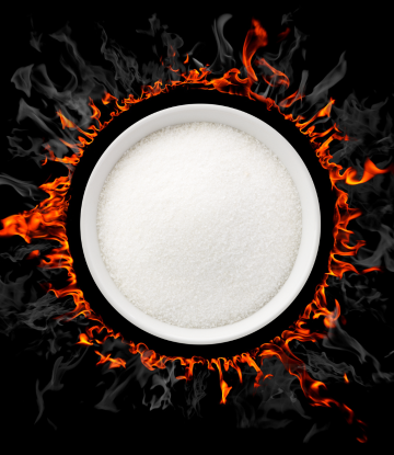 A bowl of white sugar with fire around it 